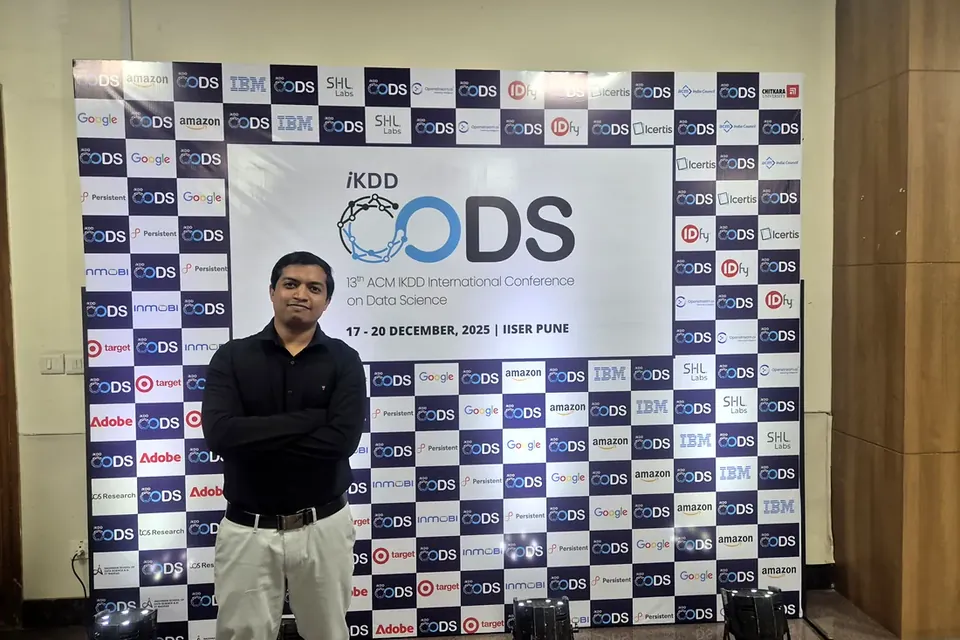 Nitin Mane beside the Autograder+ poster (P-52) at ACM CODS 2025, IISER Pune